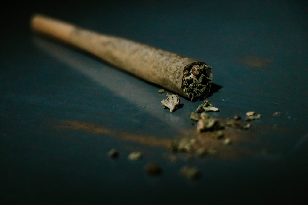 Hand-rolled pre-roll on a blue surface